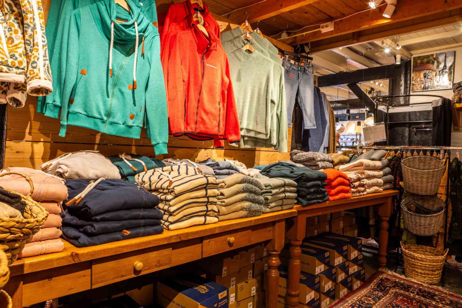 Fleece jassen en gevouwen truien op een houten tafel
